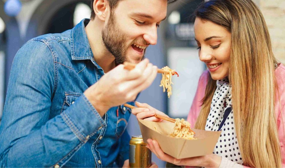 Couple sharing food in office